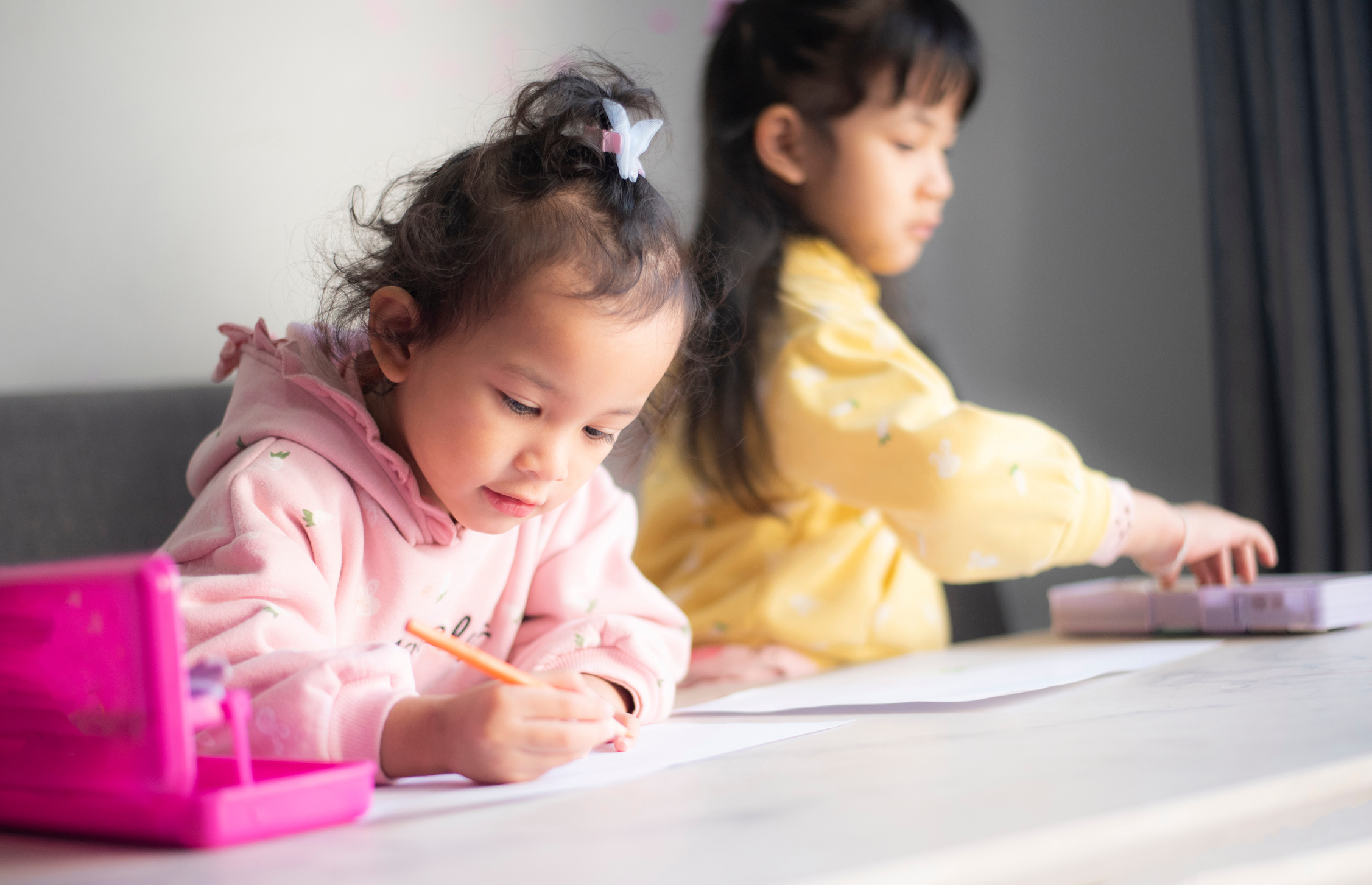 Children Writing on Paper in Daycare